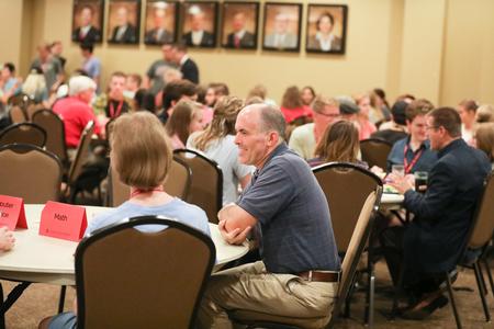 George Moss, associate professor of mathematics and department chair, chats with new math department students over dinner during Welcome Week. - Photo by Kristi McMurry Woody