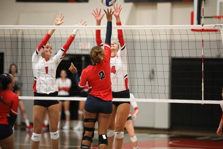 Grace Roberts and Abbie Rahn go up for a block in a volleyball game against Lane College.  - Photo by Kristi McMurry Woody