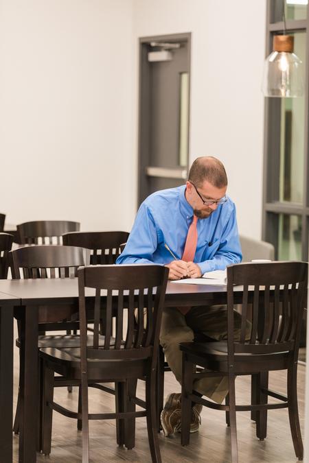 Justin Barnard, professor of philosophy, works in the Writing Center during Faculty Writing Hour. - Photo by Kristi McMurry Woody