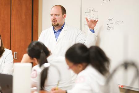 Andrew Castleman, assistant professor of pharmaceutical sciences, gives instructions for a lab. - Photo by Kristi McMurry Woody