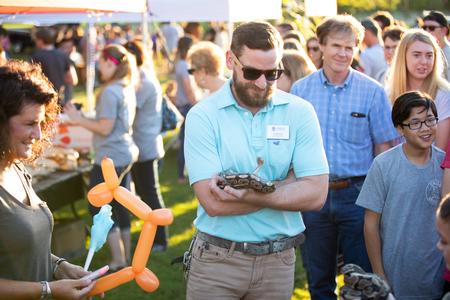 Micah Fern, assistant professor of biology, shows off some of the biology department's wildlife during Family Weekend Union Night.  - Photo by Kristi McMurry Woody