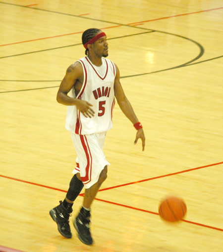 Marcus Cooper looks over his options as he brings the ball down the court. - Photo by Steven Aldridge