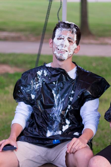 Nick Gutierrez, digital media communications major, gets a pie in the face at the SAE booth during Union Night. - Photo by Nikki Grim