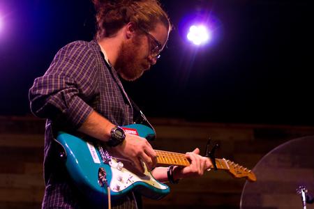 Riley Boggs, junior Christian studies major, performs with his band Tungsten Lights at Open Mic in Barefoots Joe. - Photo by Nikki Grim
