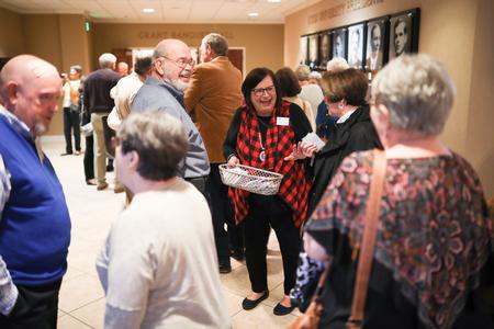 Teresa Rosson, assistant director for alumni, greets guests for the Class of 1969 50 Year Reunion welcome event. - Photo by Kristi McMurry Woody