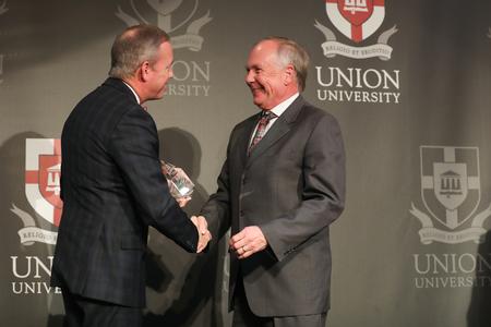 Dub Oliver, president of the university, presents Michael Pennington ('74) with the Distinguished Achievement Award in Church Ministry during the Meritorious Service Awards Banquet.  - Photo by Kristi McMurry Woody