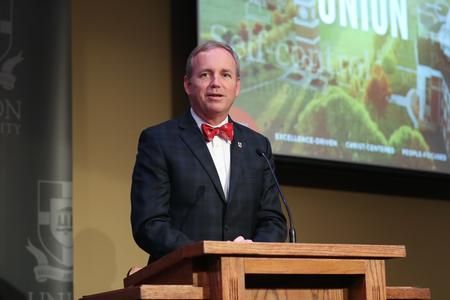 Dub Oliver, president of the university, congratulates the alumni who won awards during the Meritorious Service Awards Banquet.  - Photo by Kristi McMurry Woody