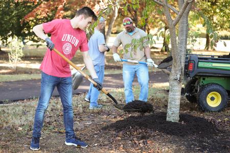 Jack Waters, history major, and his fellow students in the history department work in the Liberty Garden park for Campus and Community Day. - Photo by Kristi McMurry Woody