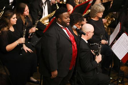 Cameron Smith, music major, sings with the Symphonic Band during the annual fall concert. - Photo by Kristi McMurry Woody