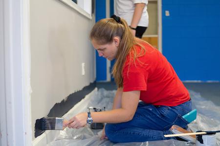 Students paint the walls of a church during Union's annual Campus & Community Day. - Photo by Nikki Grim