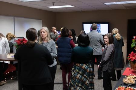 Guests of a reception celebrating the 20th anniversary of the School of Social Work mingle in the BAC. - Photo by Joey Echeverria
