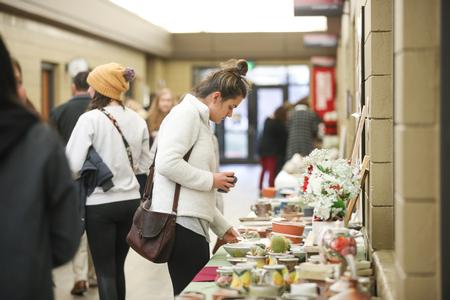 Guests enjoy the pottery sale in the SUB hallway. - Photo by Kristi McMurry Woody