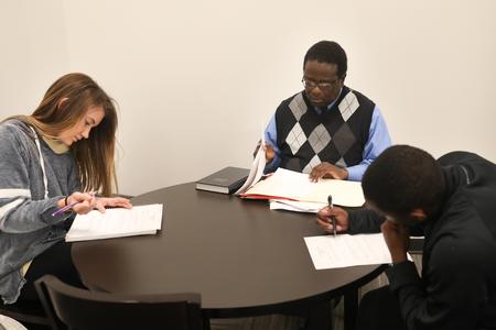 Frank Anderson, director of the Center for Racial Reconciliation, works with students in the Writing Center. - Photo by Sarah Palmer Goff