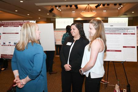 Jennifer Delk, assistant professor of nursing and chair for undergraduate programs, talks to students during the annual Scholarship Symposium. - Photo by Kristi McMurry Woody