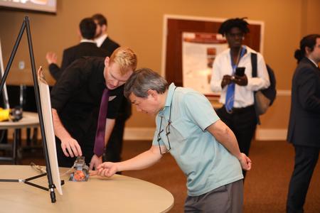 Don Van, professor of engineering, checks out a project during the annual Scholarship Symposium. - Photo by Kristi McMurry Woody