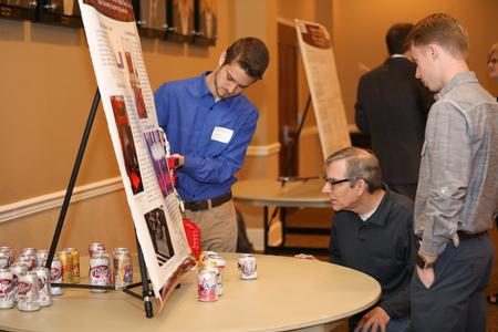 David Ward, professor of physics, checks out a project during the annual Scholarship Symposium. - Photo by Kristi McMurry Woody