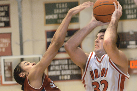 Senior Bruno Martinessi attempts a shot over a Lyon
defender. Martinessi posted 14 points during his final home game. - Photo by Jonathan Blair