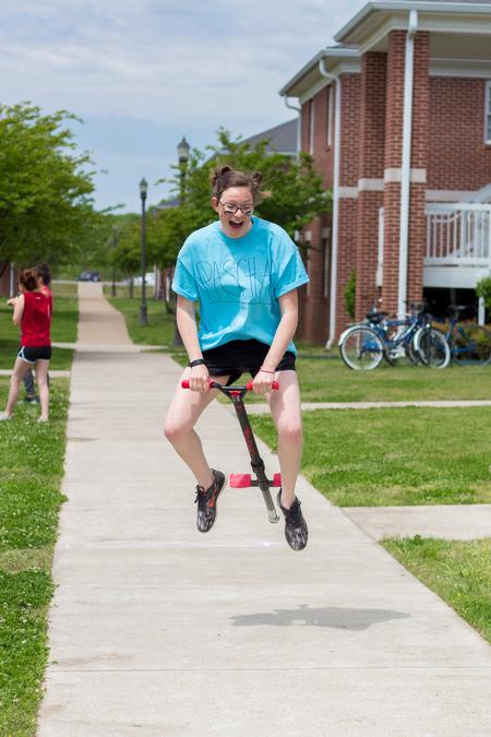 Abigail Johnson, music education major, participates in the pogo stick race during Residence Life Field Day. - Photo by Nikki Grim