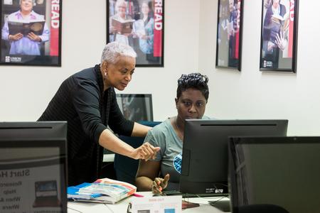 Shirley Harris, Germantown campus librarian, helps a students with her work in the library. - Photo by Kristi McMurry Woody