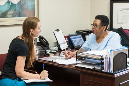 Karen Dotson, assistant professor of social work and field director, meets with a student in her office on the Germantown campus. - Photo by Kristi McMurry Woody