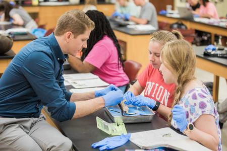 Jeremy Blaschke, assistant professor of biology, works with students on a dissection lab. - Photo by Kristi McMurry Woody