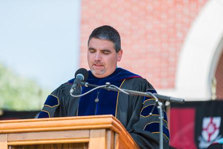 Blake Watson, professor of pharmaceutical sciences and chair, delivers the invocation at spring commencement. - Photo by Kristi McMurry Woody