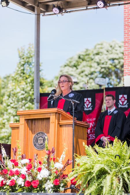 Kim McNeil, program coodinator for the School of Social Work, reads John 17:20-23 during spring commencement. - Photo by Kristi McMurry Woody