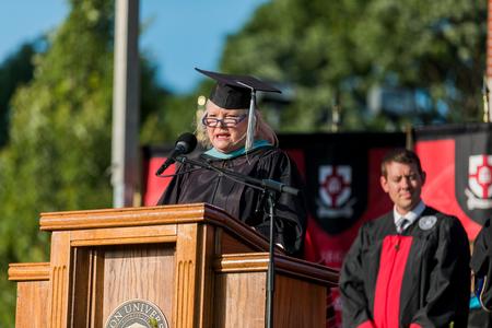 Melessia Mathis, assistant professor in the College of Education, reads from the gospel of John during spring commencement. - Photo by Kristi McMurry Woody