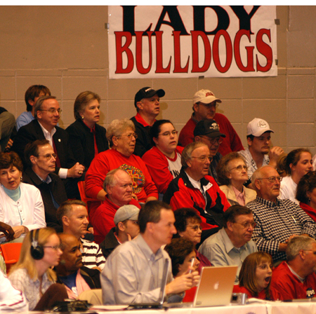 Dr. and Mrs. Dockery, along with numerous other Union fans, watch during Union's semifinal win in the NAIA Women's National Tournament. - Photo by Morris Abernathy
