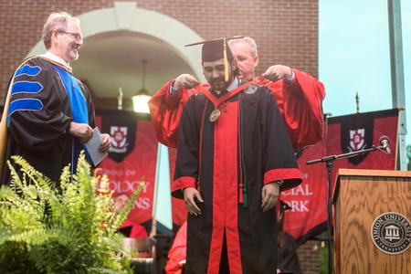 Thomas Lunsford, cell and molecular biology graduate, receives the Tigrett Medal at the end of spring commencement. - Photo by Kristi McMurry Woody