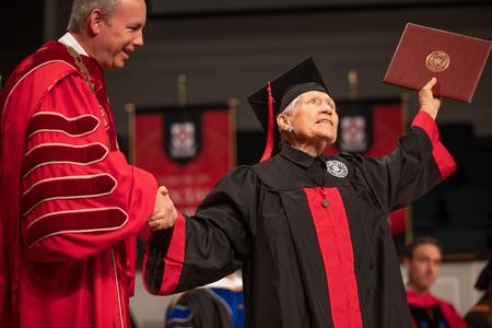 Ellen Holland, associate of Christian studies graduate, celebrates after receiving her diploma. - Photo by Kristi McMurry Woody