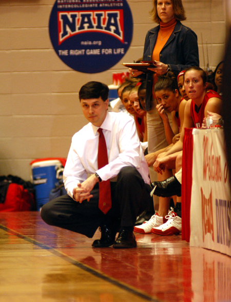 Head coach Mark Campbell watches from the sideline as his Lady Bulldogs perfom in the opening round of the 2005 NAIA National Tournament. - Photo by Morris Abernathy