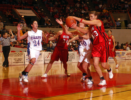 Stephanie Clark and a Lubbock Christian player battle for a loose rebound in Union 77-55 opening round win in the 2005 NAIA National Tournament. - Photo by Morris Abernathy