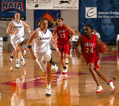 Senior guard Monica Elliot (24) brings the ball down the court in Union's quarterfinal match-up with top seeded Vanguard in the 2005 NAIA National Tournament.  Union won this game 87-72. - Photo by Morris Abernathy