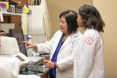 Lunawati Bennet, professor of pharmaceutical sciences, and Victoria Downs, doctor of pharmacy student, work in the lab. - Photo by Kristi McMurry Woody