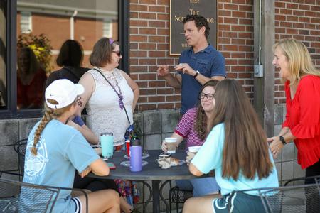 Students and faculty in the intercultural studies chat on the Barefoots Joe patio during a breakfast event. - Photo by Kristi McMurry Woody