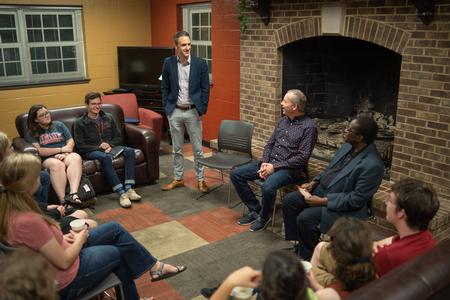 Jason Crawford, associate professor of English and faculty in residence, welcomes students to the new Fireside Forum event in the Bowld Student Commons. Dub Oliver, president of the university, was the inaugural speaker. - Photo by Kristi McMurry Woody
