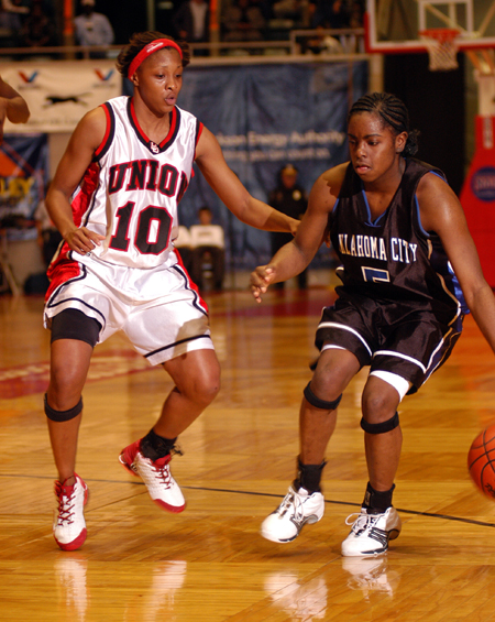 Ena Daniels (10) plays defense on an Oklahoma City player in finals of the NAIA National Tournament.   - Photo by Morris Abernathy