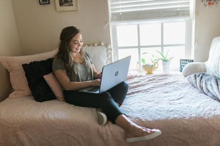 Chloe Thomas, studio art major, studies in her dorm room. - Photo by Kristi McMurry Woody
