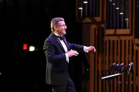 John Kitchen, professor of music and department chair, directs students during the Fall Choral Concert.  - Photo by Kristi McMurry Woody