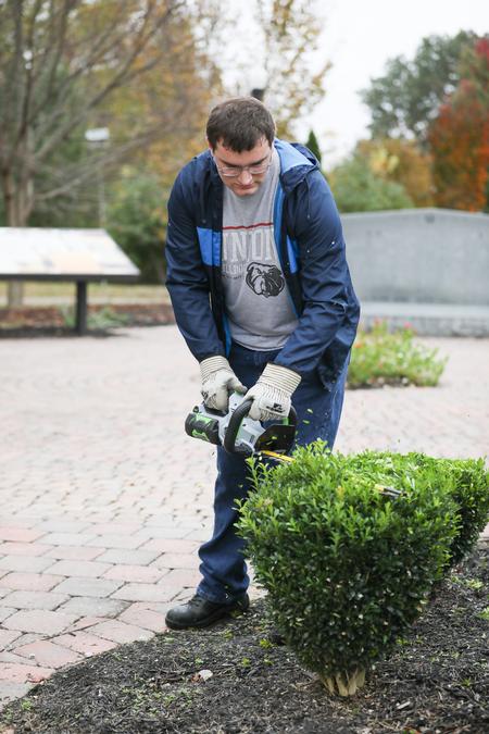 Miles Randall, film studies major, helps with a project at Liberty Park during Campus and Community Day. - Photo by Kristi McMurry Woody