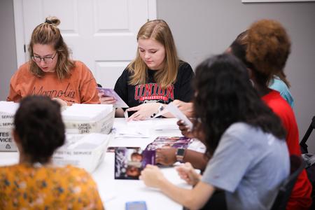 Students stuff envelopes with Christmas cards at Birth Choice during Campus and Community Day. - Photo by Kristi McMurry Woody