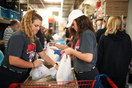 Players on the lady bulldog softball team pack bags at RIFA during Campus and Community Day. - Photo by Kristi McMurry Woody