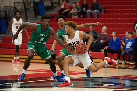 Tyree Boykin drives to the basket during a basketball game against West Florida. - Photo by Kristi McMurry Woody