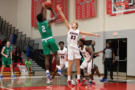 Cooper Meadows plays defense during a basketball game against West Florida. - Photo by Kristi McMurry Woody