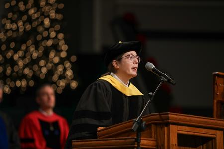 Beth Madison, associate professor of science, opens fall commencement services with prayer. - Photo by Kristi McMurry Woody