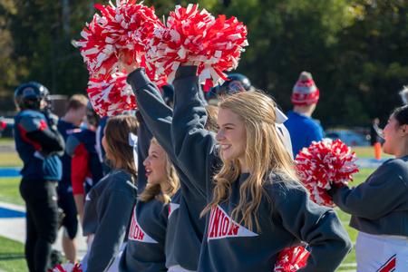 Union cheerleaders pump up the crowd during the Buster Bowl alumni football game.  - Photo by Nikki Grim