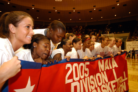 Senior guard Laura Mitchell is nothing but smiles as she along with the rest of her teammates hold up the championship banner after Union's win in the title game. - Photo by Morris Abernathy