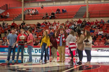 Winners of the Presidential Cup celebrate during halftime of the Homecoming women's basketball game. - Photo by Nikki Grim
