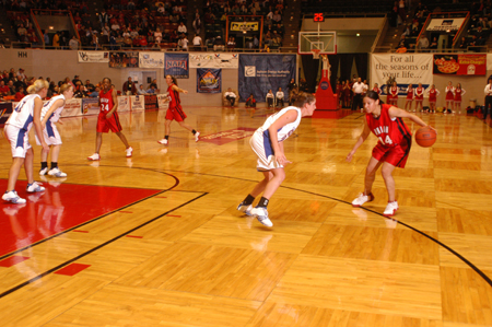 Union's Tiffany Fisher (14) handles the ball as the Lady Bulldogs set their offence during the 77-55 win over Lubbock Christian in the first round of the 2005 NAIA National Tournament. - Photo by Morris Abernathy